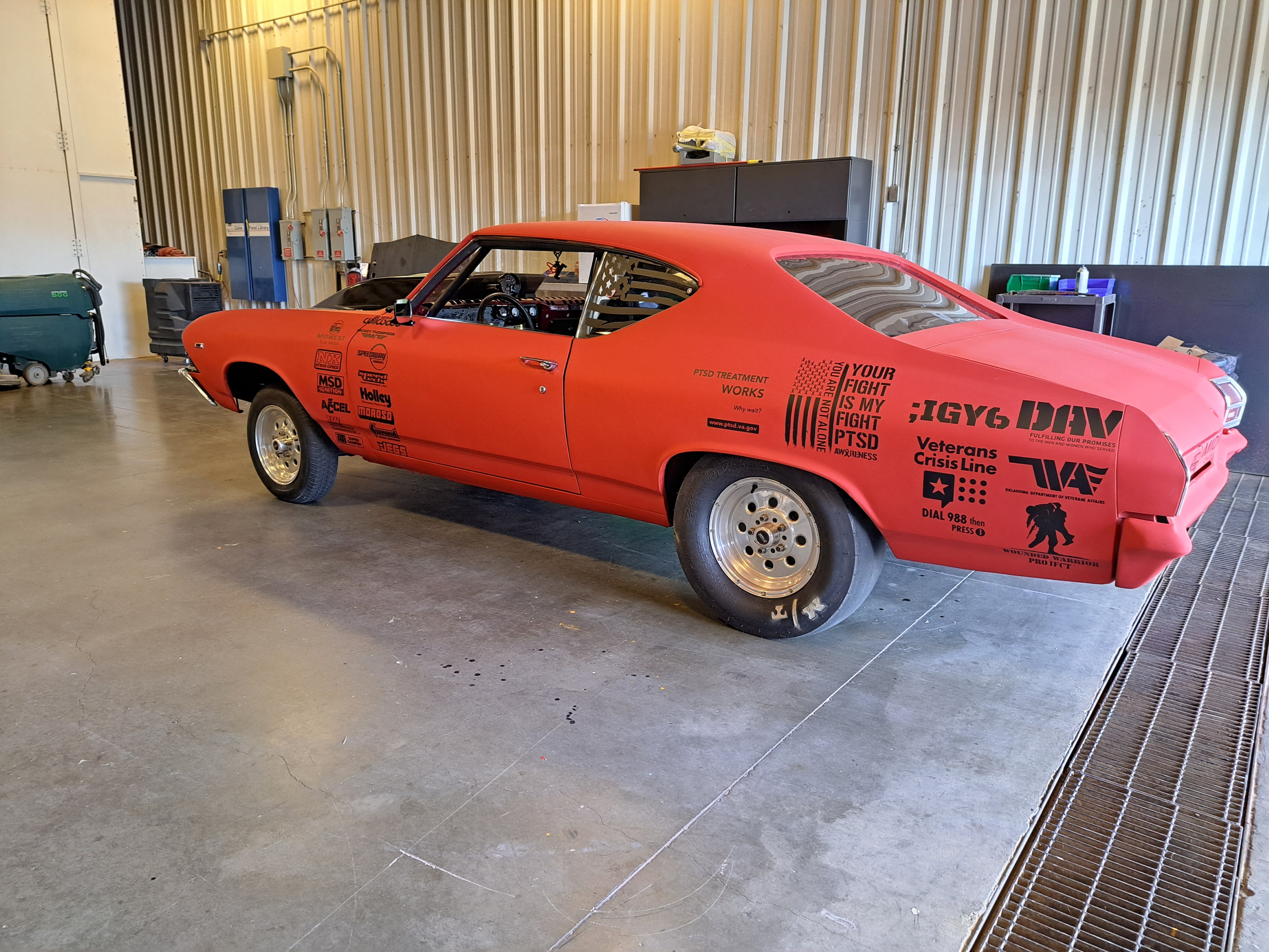 Red custom Chevelle with PTSD awareness and veteran sponsor graphics